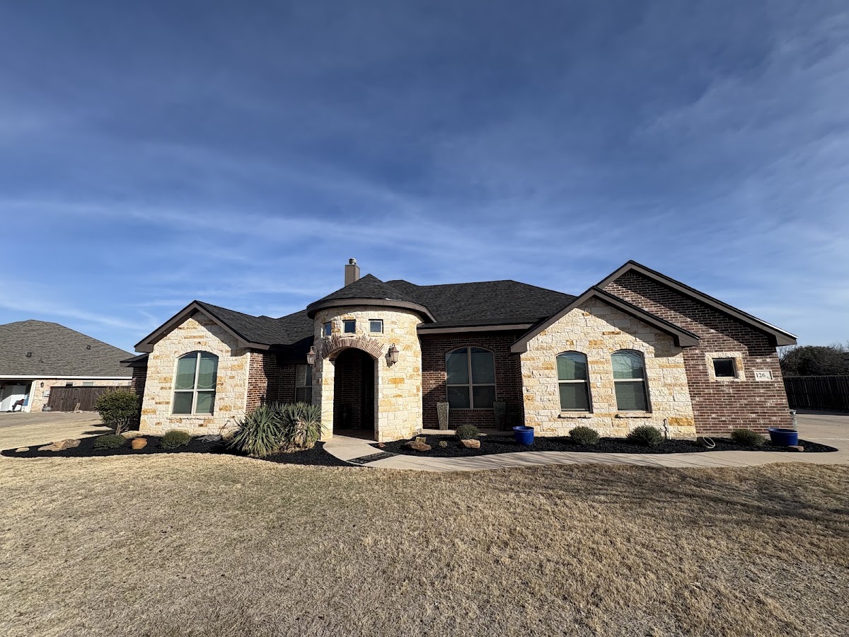 Stone house with a tidy front yard