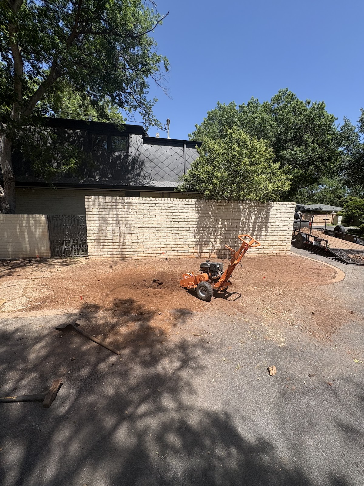 Stump grinder working on cleared land